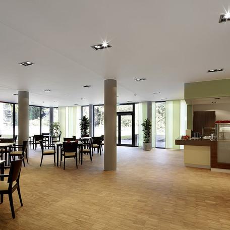 Aufenthaltsraum des Seniorenpflegezentrum in Alsdorf mit Kueche und Essenausgabe, Tischen mit vielen Sitzmoeglichkeiten und grossen Fensterfassaden
