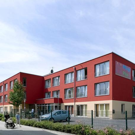 Seniorenzentrum in Duisburg von aussen mit Parkplatz und rot beige Fassade