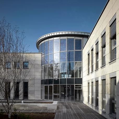 Fokus auf den Eingang des Verwaltungsgebaeude in Duisburg von aussen mit gewoelbter Glasfront